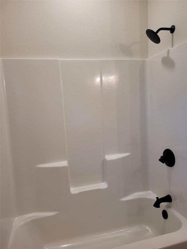 bathroom with shower / washtub combination