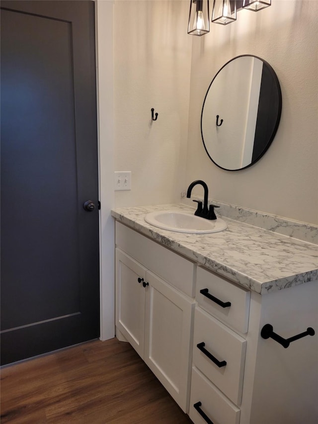 bathroom with vanity and hardwood / wood-style floors