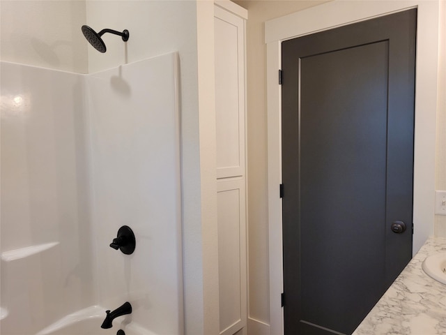 bathroom featuring vanity and  shower combination