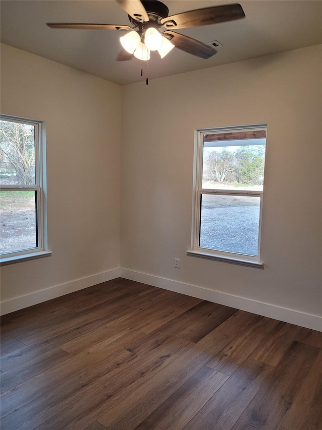 unfurnished room with dark wood-type flooring and ceiling fan