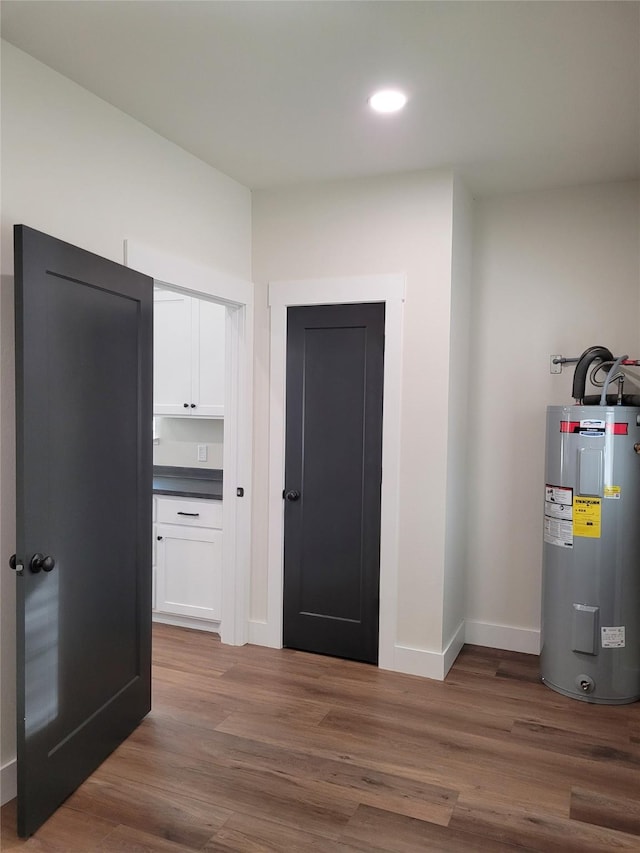 hall featuring dark hardwood / wood-style flooring and electric water heater