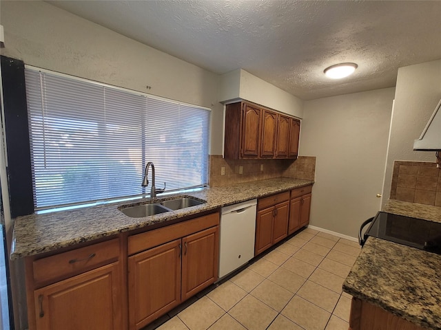 kitchen with tasteful backsplash, sink, stove, light tile patterned floors, and white dishwasher