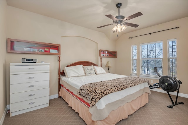 carpeted bedroom featuring vaulted ceiling and ceiling fan