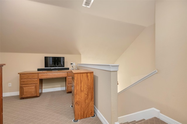 office space featuring lofted ceiling and light carpet