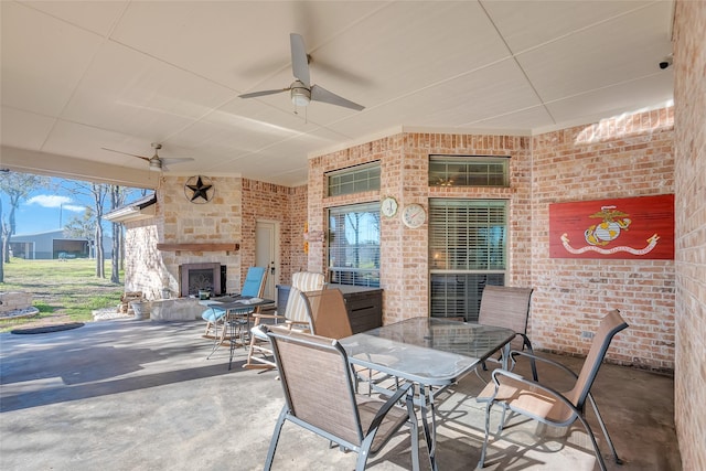 view of patio featuring ceiling fan and an outdoor stone fireplace