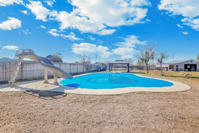 view of swimming pool with a gazebo, a water slide, and a lawn