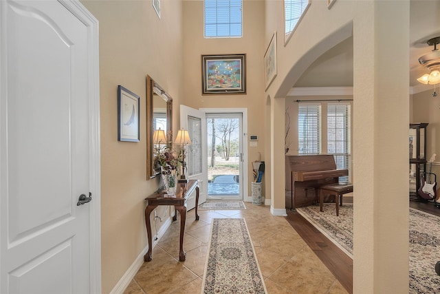 tiled foyer featuring a high ceiling