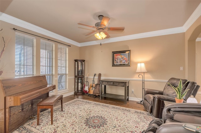 living area with crown molding, ceiling fan, and light hardwood / wood-style flooring