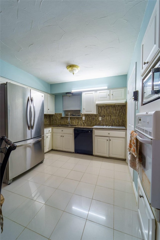 kitchen with stainless steel refrigerator, white cabinets, dishwasher, and oven