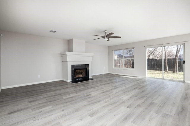 unfurnished living room with light hardwood / wood-style flooring and ceiling fan