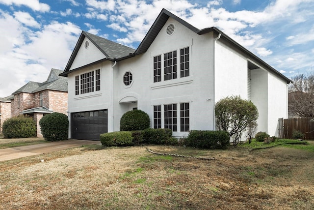 view of front of home featuring a garage and a front lawn