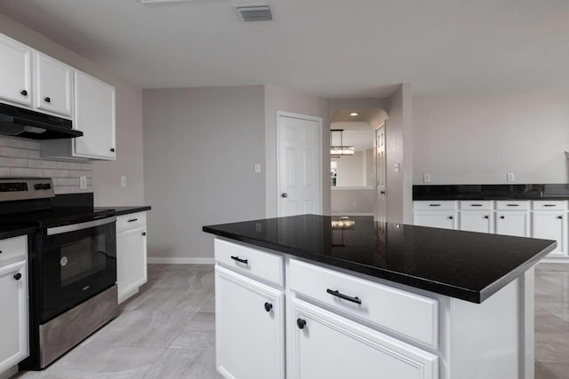 kitchen featuring backsplash, a kitchen island, white cabinets, and stainless steel electric range oven