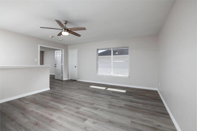 spare room with dark hardwood / wood-style floors and ceiling fan