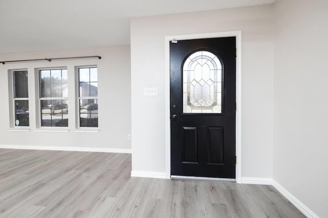 foyer entrance featuring light wood-type flooring and baseboards