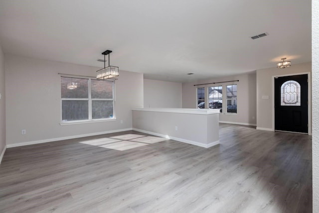 interior space featuring wood-type flooring and a chandelier