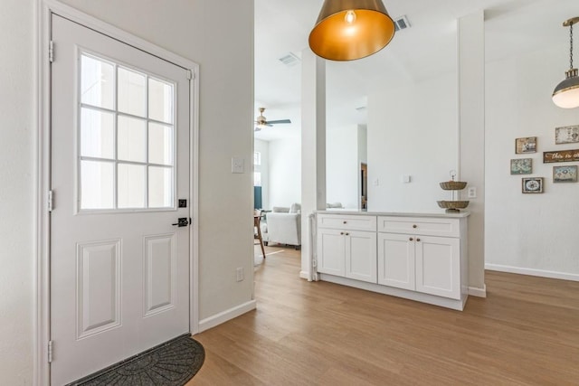 doorway to outside featuring ceiling fan and light wood-type flooring