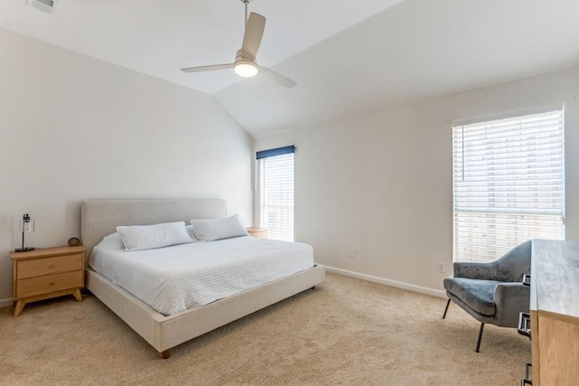 bedroom featuring multiple windows, vaulted ceiling, light colored carpet, and ceiling fan