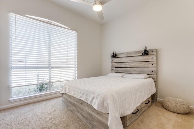 bedroom with light carpet and ceiling fan