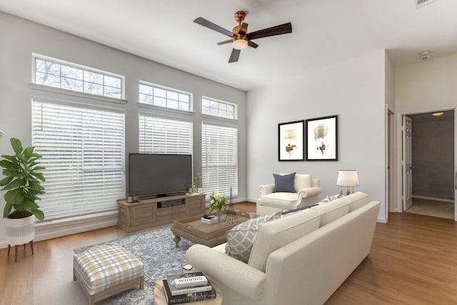 living room with hardwood / wood-style floors and ceiling fan