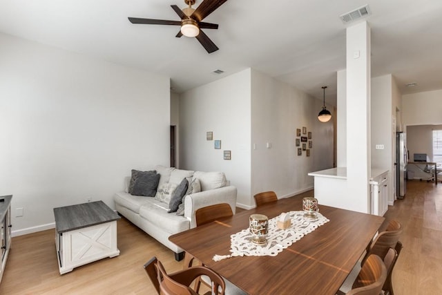 dining room featuring light hardwood / wood-style floors and ceiling fan