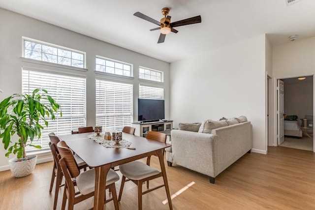 dining room with ceiling fan and light hardwood / wood-style flooring