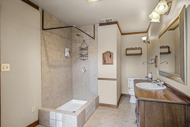 bathroom with tiled shower, tile patterned floors, toilet, crown molding, and vanity