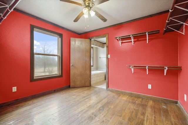 spare room with hardwood / wood-style floors and ceiling fan