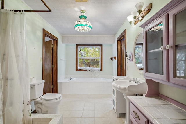 bathroom with tile patterned floors, tiled bath, and toilet