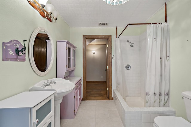 bathroom with toilet, tile patterned floors, and a shower with shower curtain