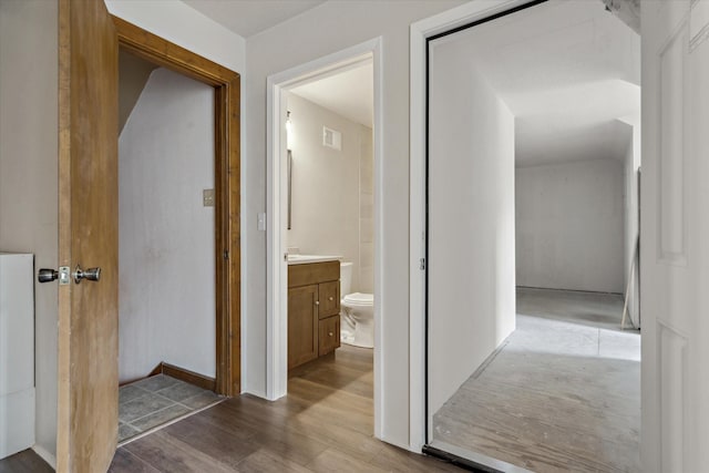 hallway with light hardwood / wood-style flooring