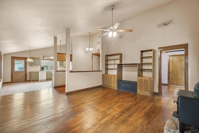 unfurnished living room with dark hardwood / wood-style flooring, high vaulted ceiling, and ceiling fan