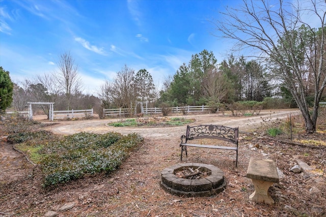 view of yard with an outdoor fire pit