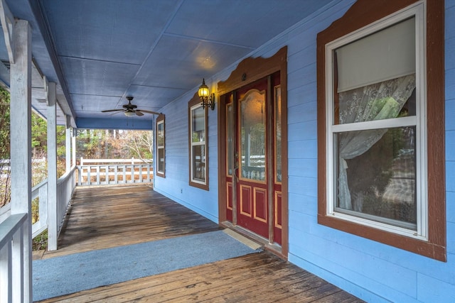 wooden deck with ceiling fan and covered porch