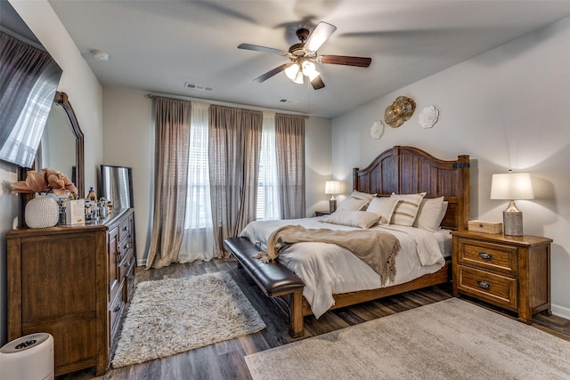 bedroom with dark hardwood / wood-style floors and ceiling fan