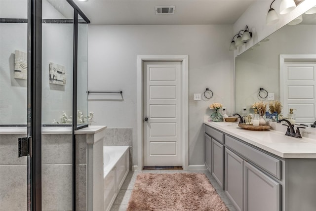 bathroom featuring vanity, tile patterned floors, and a bathing tub