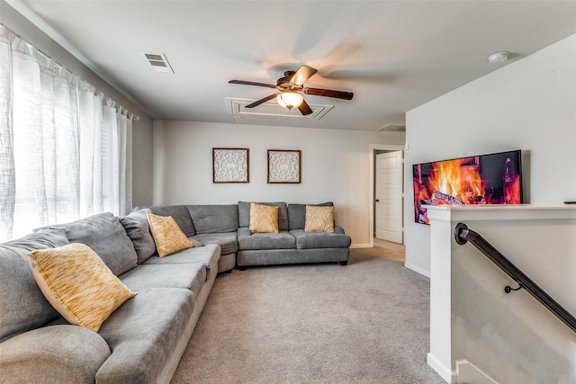 carpeted living room featuring ceiling fan