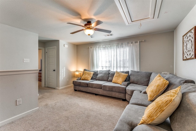 carpeted living room featuring a textured ceiling and ceiling fan