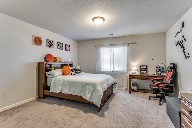 bedroom featuring light carpet and a textured ceiling