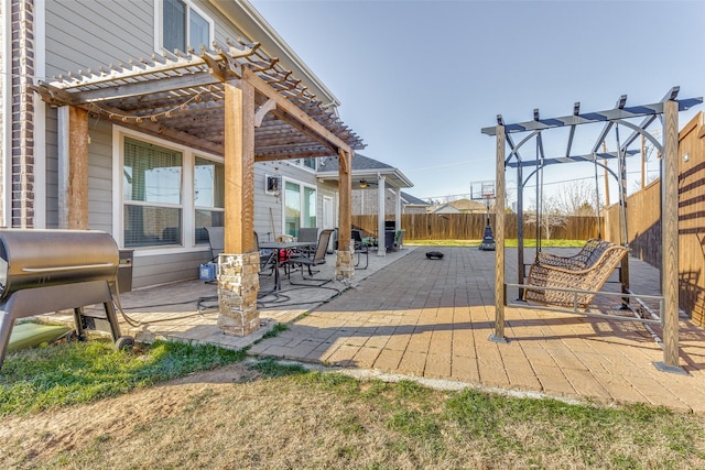 view of patio with area for grilling and a pergola