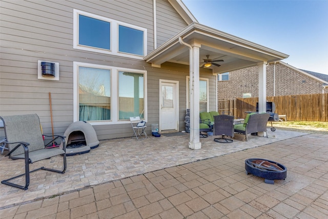 view of patio featuring ceiling fan and an outdoor fire pit