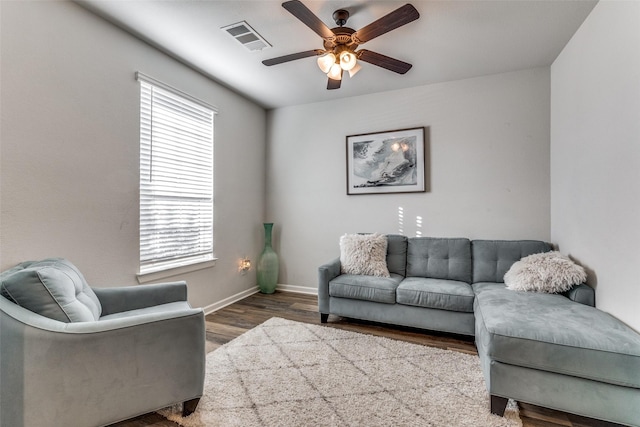 living room with wood-type flooring and ceiling fan