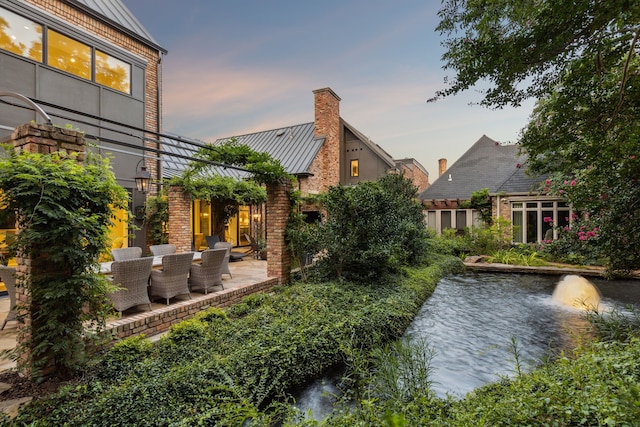 yard at dusk with a patio