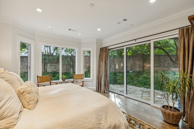 bedroom featuring ornamental molding, hardwood / wood-style floors, and access to exterior