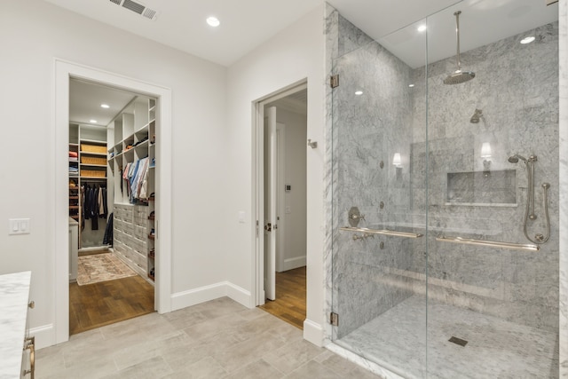 bathroom with hardwood / wood-style flooring and a shower with door