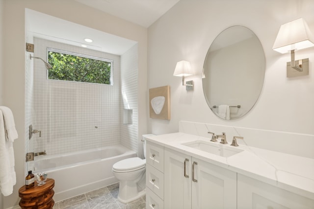 full bathroom with tiled shower / bath, vanity, and toilet