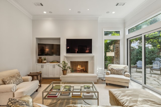 living room featuring crown molding and light hardwood / wood-style floors