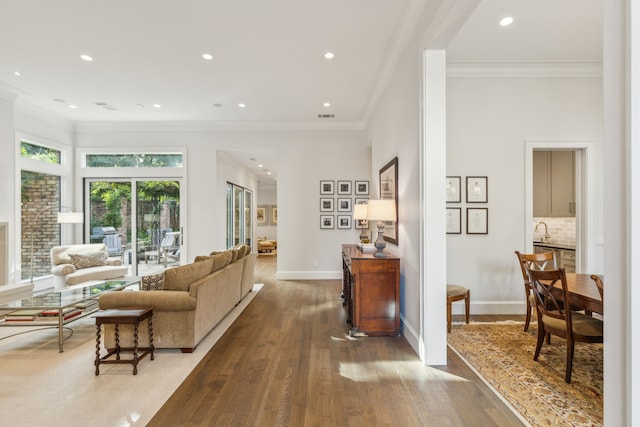 living room featuring crown molding and hardwood / wood-style floors