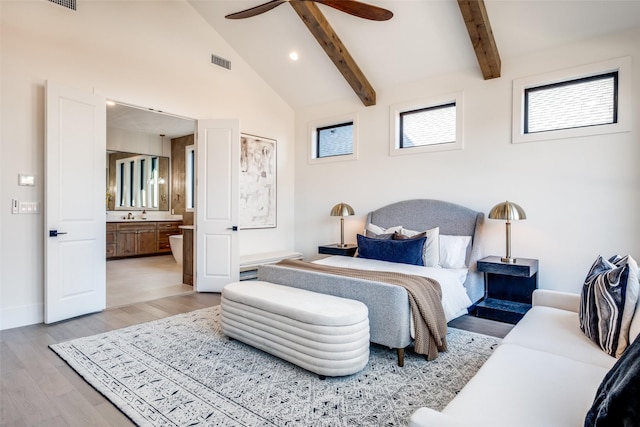 bedroom featuring ensuite bathroom, high vaulted ceiling, beamed ceiling, ceiling fan, and light hardwood / wood-style floors