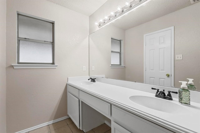 bathroom with tile patterned flooring, vanity, and a textured ceiling