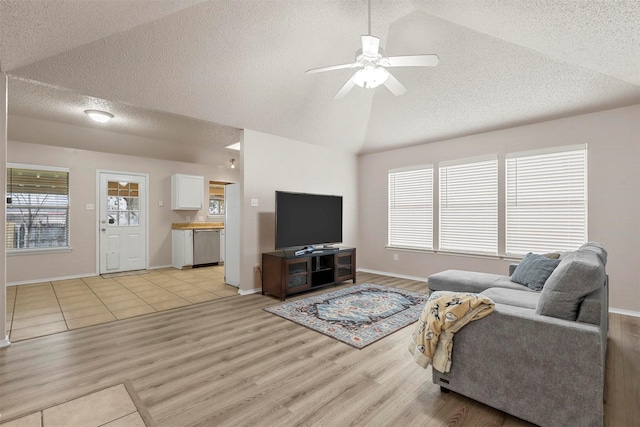 living room with vaulted ceiling, ceiling fan, and light hardwood / wood-style flooring